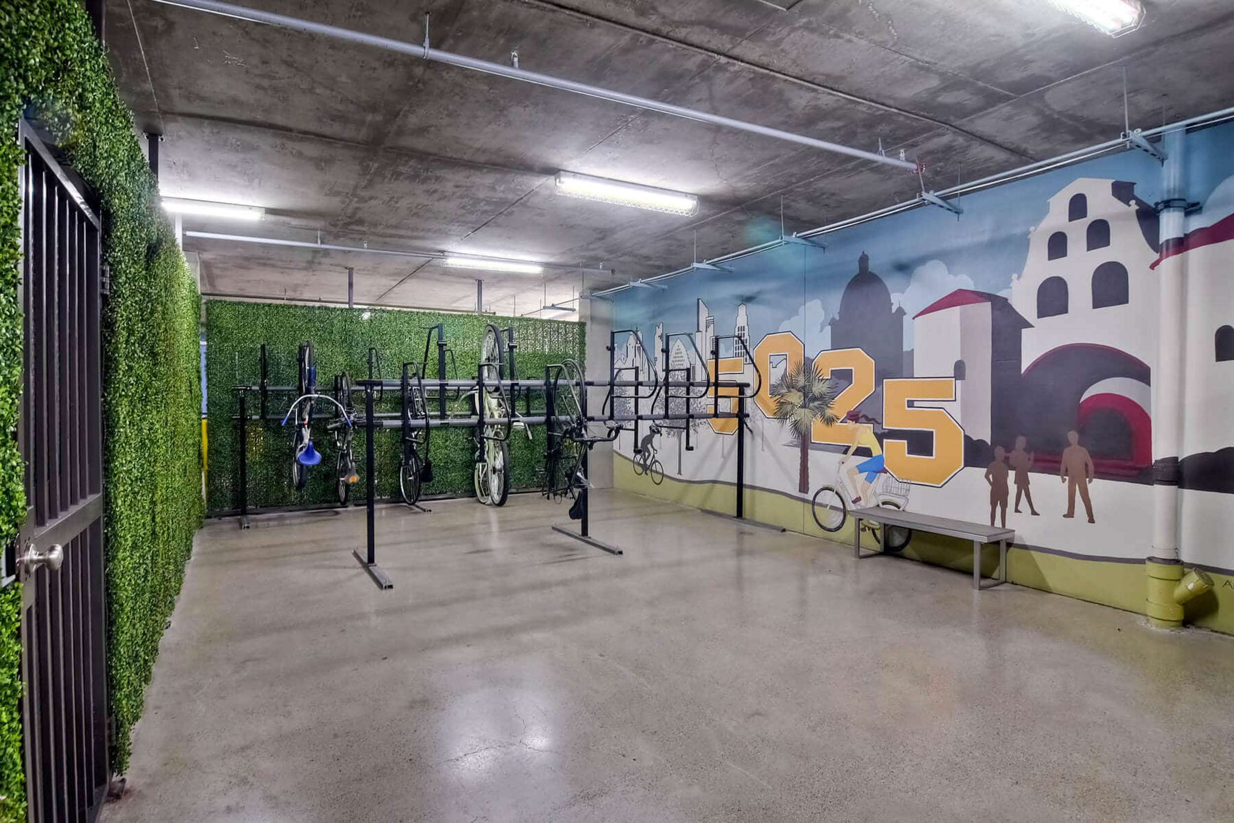 Bike storage with faux greenery and mural