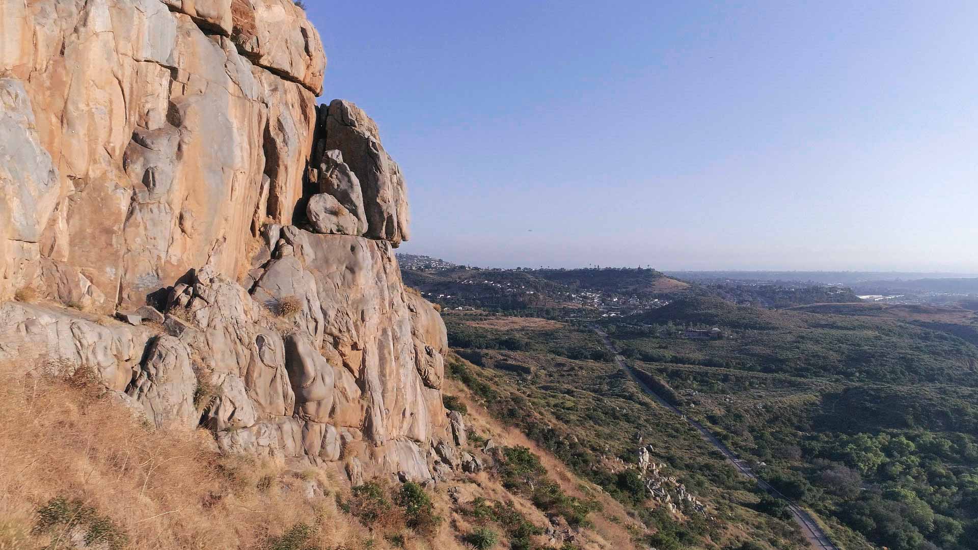 Rocky cliff view of Mission Trails Regional Park with a valley in the background