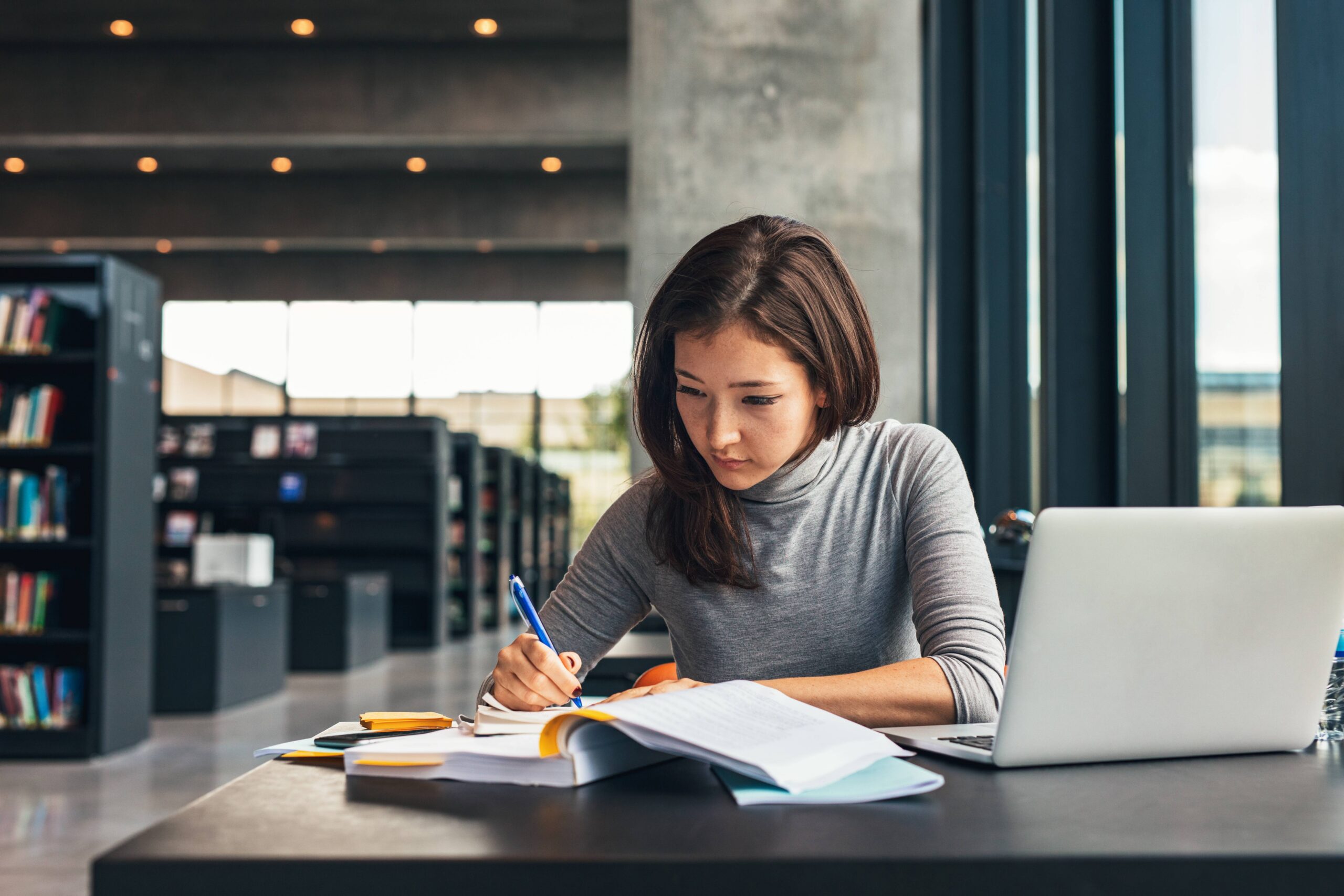 student studying for college finals at their desk