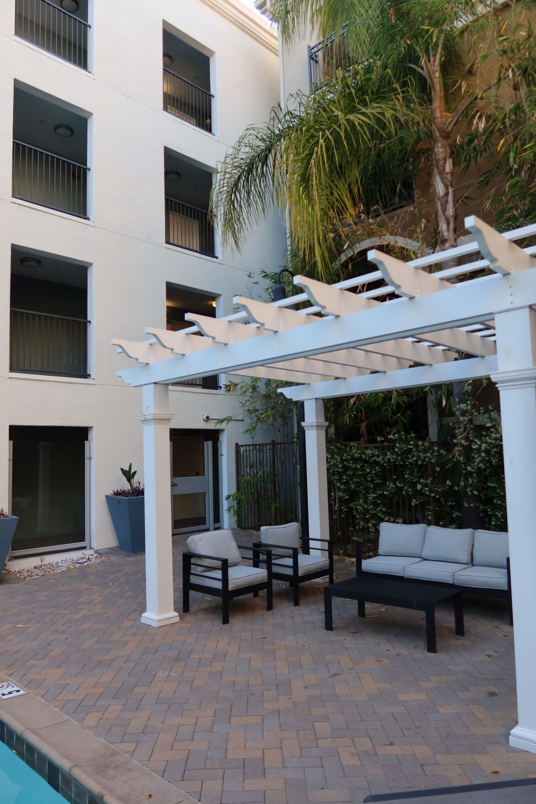 outdoor apartment courtyard pergola lounge scaled