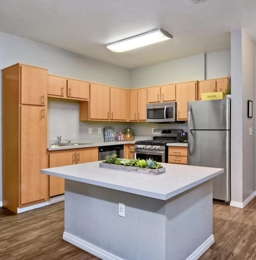 Apartment kitchen with island and wood cabinets edited